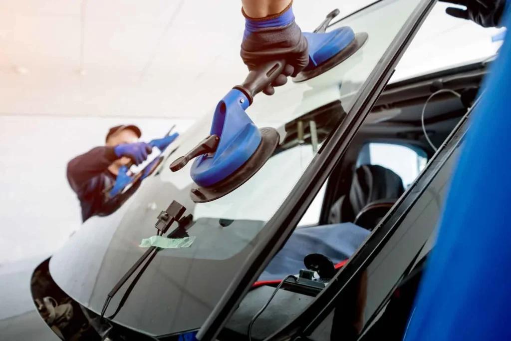 automobile-special-workers-replacing-windscreen-or-windshield-of-a-car-in-auto-service-station-garage